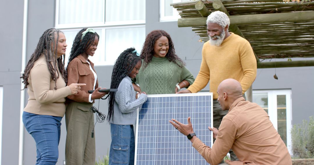 Multigenerational Black Family Learning Solar Technology While Installing Home Photovoltaic Panel