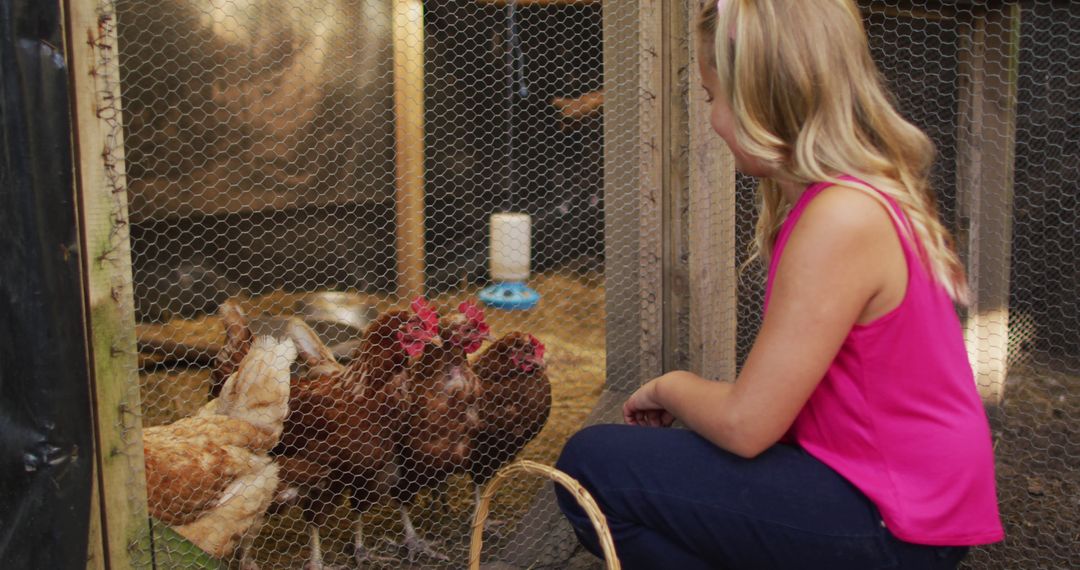 Young girl interacting with chickens in backyard chicken coop - Free Images, Stock Photos and Pictures on Pikwizard.com