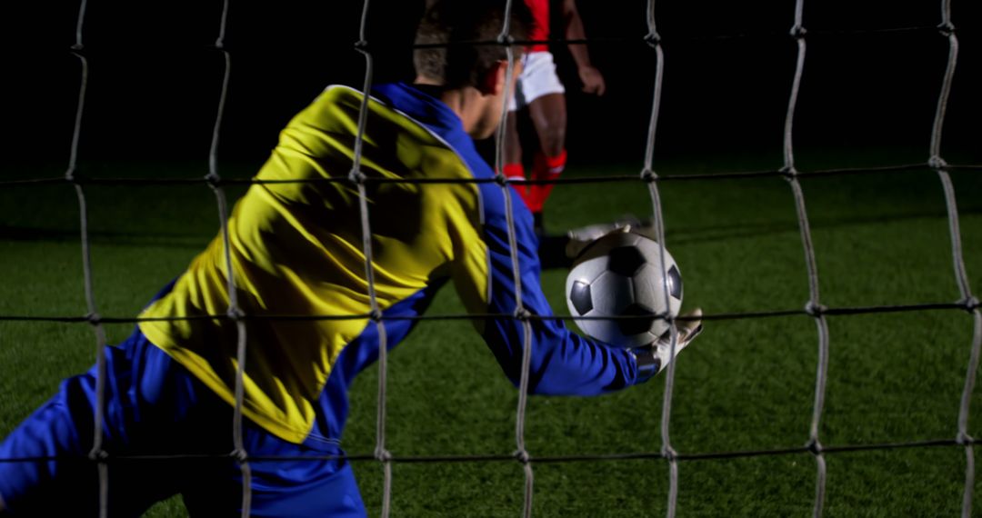 Goalkeeper Catching Soccer Ball During Night Match - Free Images, Stock Photos and Pictures on Pikwizard.com