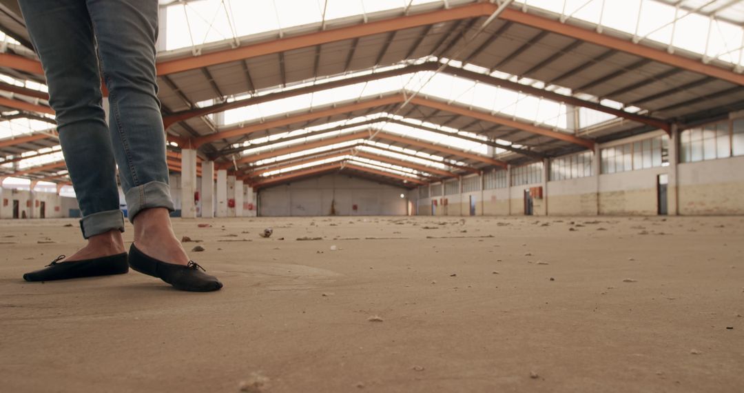 Person in Black Shoes Standing Inside Abandoned Warehouse - Free Images, Stock Photos and Pictures on Pikwizard.com