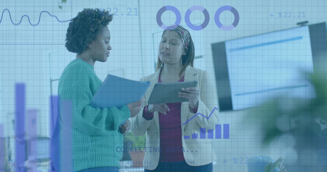 Diverse Businesswomen Discussing Data Analysis in Modern Office