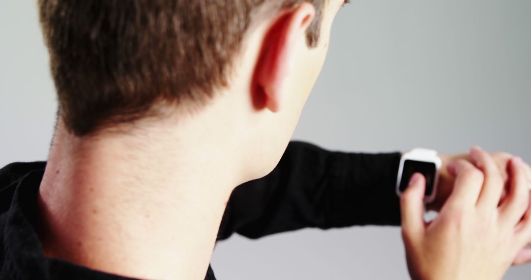 Man Checking Smartwatch with Focused Attention