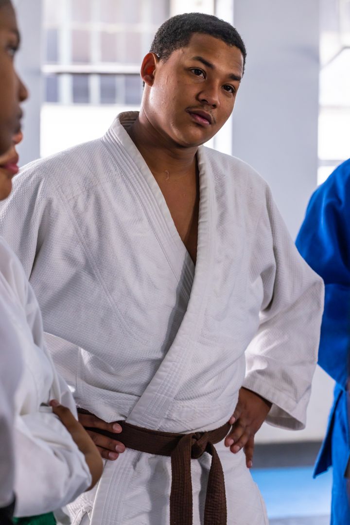 Martial Arts Enthusiast in Discussions at Dojo Training Session