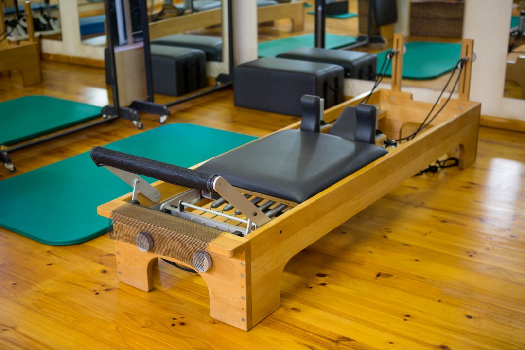 Pilates Reformer in Gym on Wooden Floor - Free Images, Stock Photos and Pictures on Pikwizard.com