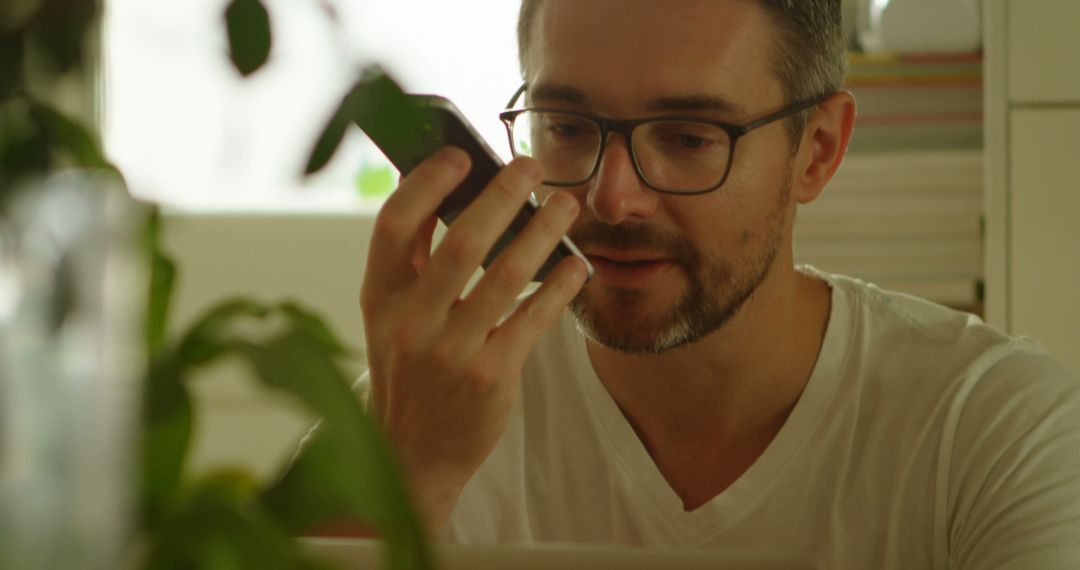 Man Recording Voice Message While Multitasking at Home - Free Images, Stock Photos and Pictures on Pikwizard.com