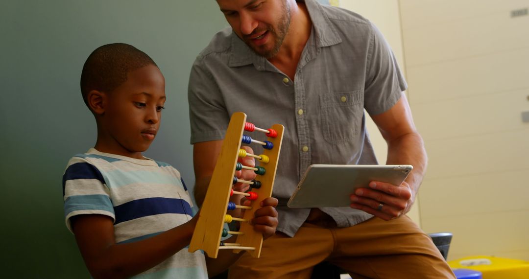 Young Teacher Using Technology and Abacus in Classroom Interaction