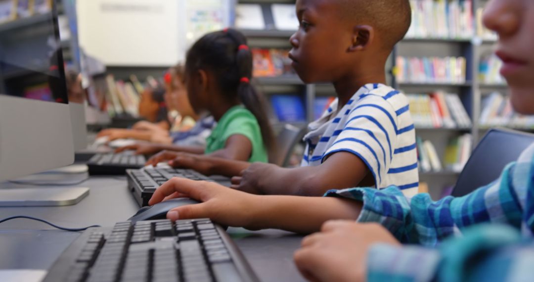 Diverse Schoolchildren Focused on Using Computers in School Library