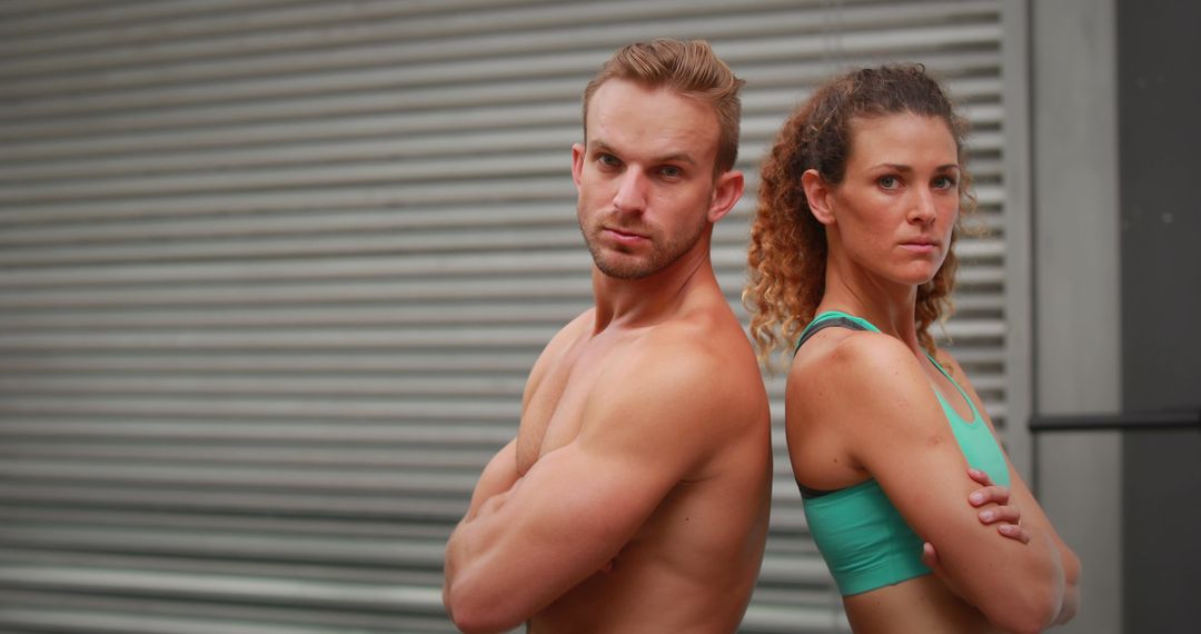 Fit Duo Standing Back-to-Back in Urban Area