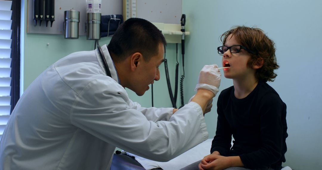 Doctor Examining Young Boy's Throat - Free Images, Stock Photos and Pictures on Pikwizard.com