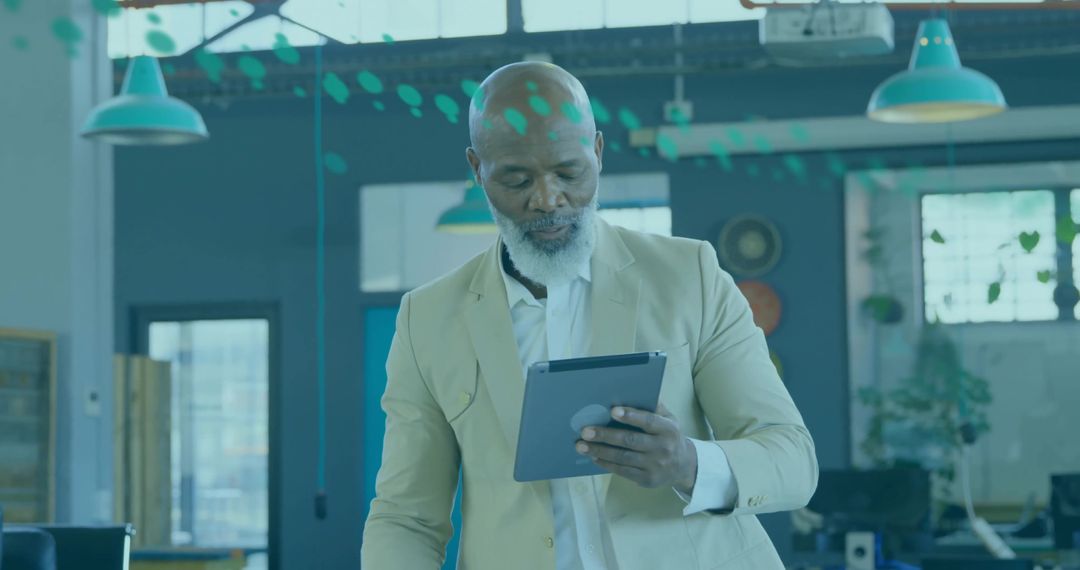 Senior Executive Using Tablet in Modern Open Plan Office