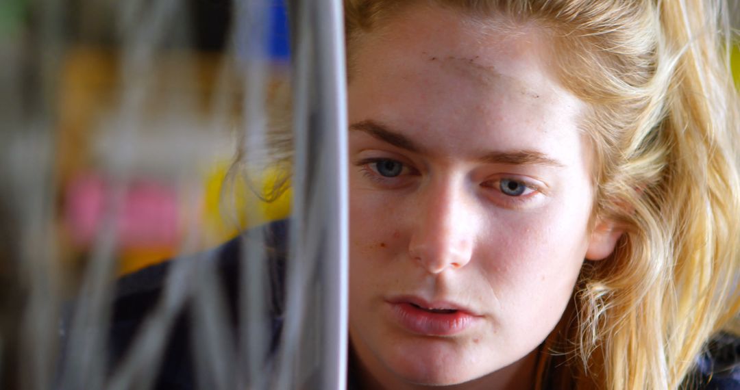 Young Caucasian woman focuses intently on a computer screen at home - Free Images, Stock Photos and Pictures on Pikwizard.com