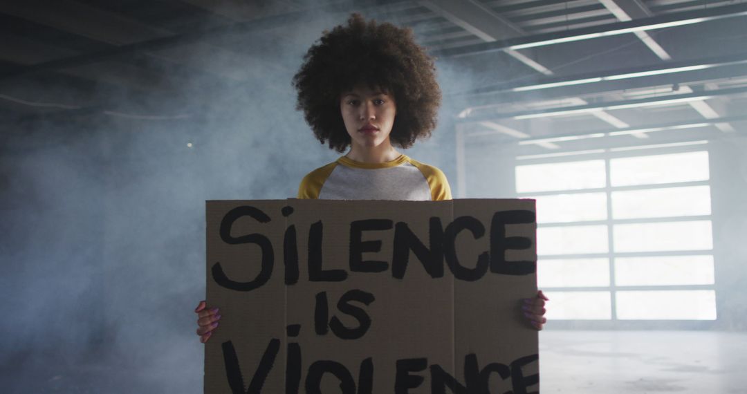 Young Woman Holding Protest Sign Shouting 'Silence Is Violence' - Free Images, Stock Photos and Pictures on Pikwizard.com