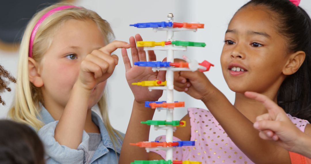 Children Collaborating to Build Structure with Colorful Blocks