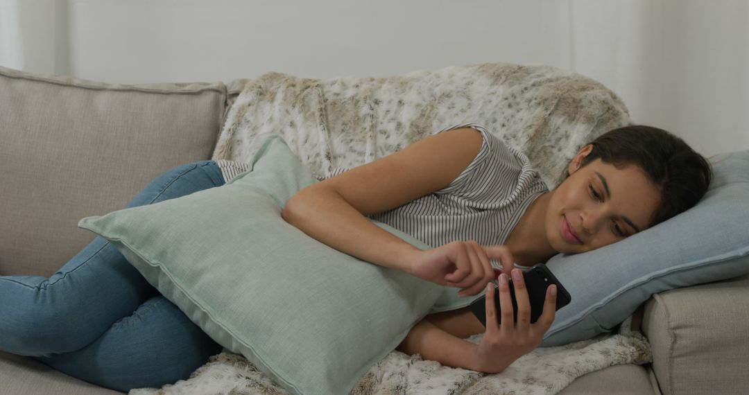 Teenage Girl Relaxing On Couch Using Smartphone - Free Images, Stock Photos and Pictures on Pikwizard.com