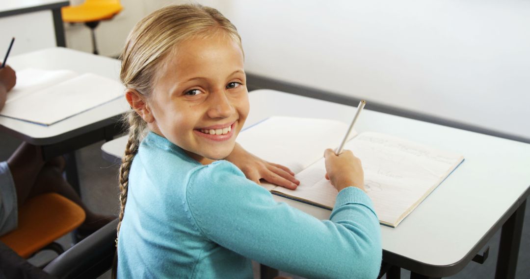 Smiling Schoolgirl Studying in Classroom - Free Images, Stock Photos and Pictures on Pikwizard.com