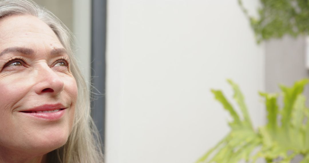 Senior Woman Smiling Softly Amid Natural Tranquility