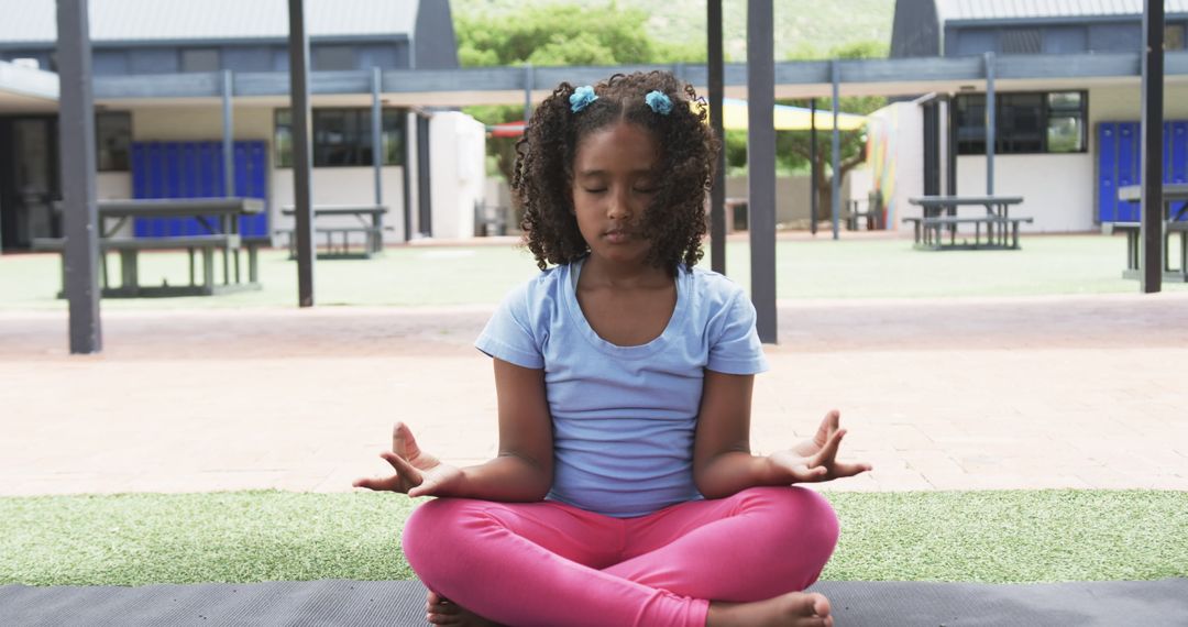 Young Girl Practicing Meditation in Schoolyard