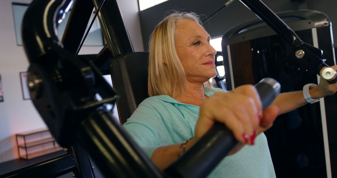 Senior Woman Exercising on Chest Press Machine in Gym - Free Images, Stock Photos and Pictures on Pikwizard.com