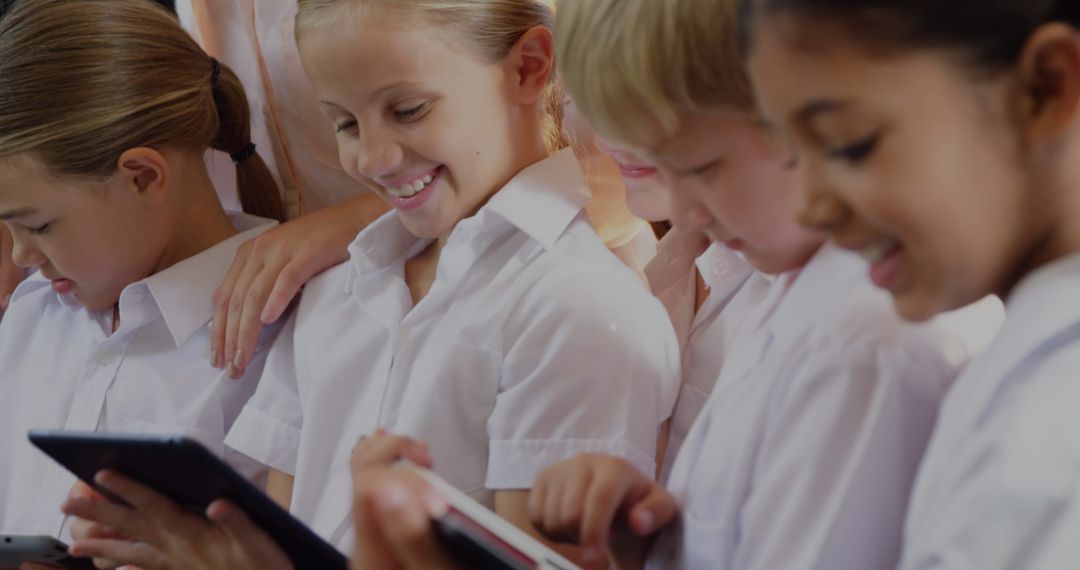 Diverse Schoolchildren Engaged with Digital Tablets in Classroom