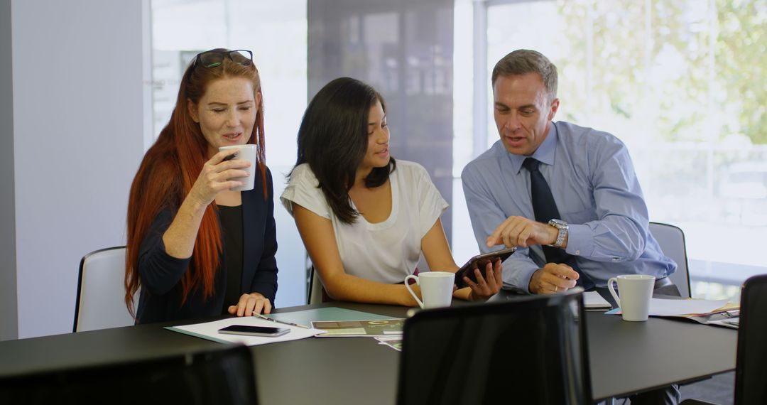 Business Team Discussing Project on Mobile Device in Office - Free Images, Stock Photos and Pictures on Pikwizard.com