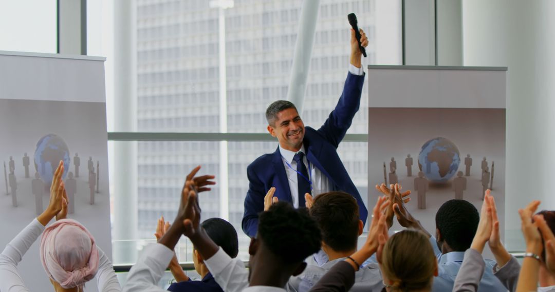 A businessman celebrates success to applause at a seminar in a 4K front view. - Free Images, Stock Photos and Pictures on Pikwizard.com