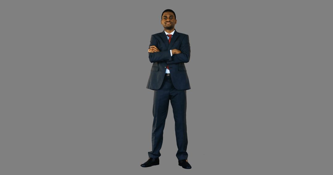 Confident Businessman Standing with Arms Crossed on Grey Background