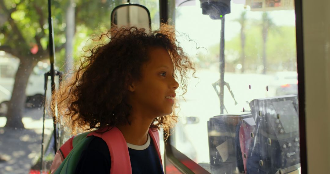 Joyful Child with Backpack Rides City Bus