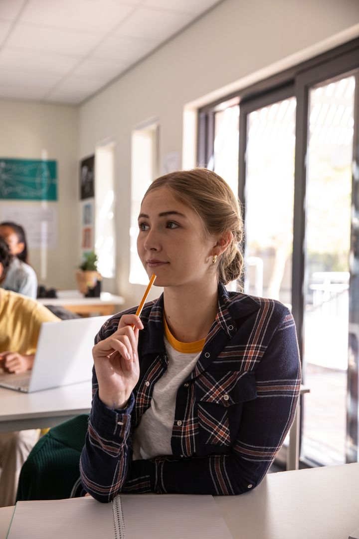 Thoughtful Student Contemplating in Modern Classroom