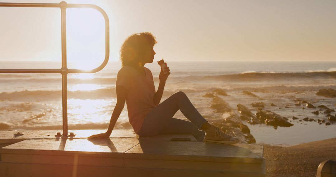 Woman Relaxing by Seaside in Sunset Light with Beverage - Free Images, Stock Photos and Pictures on Pikwizard.com