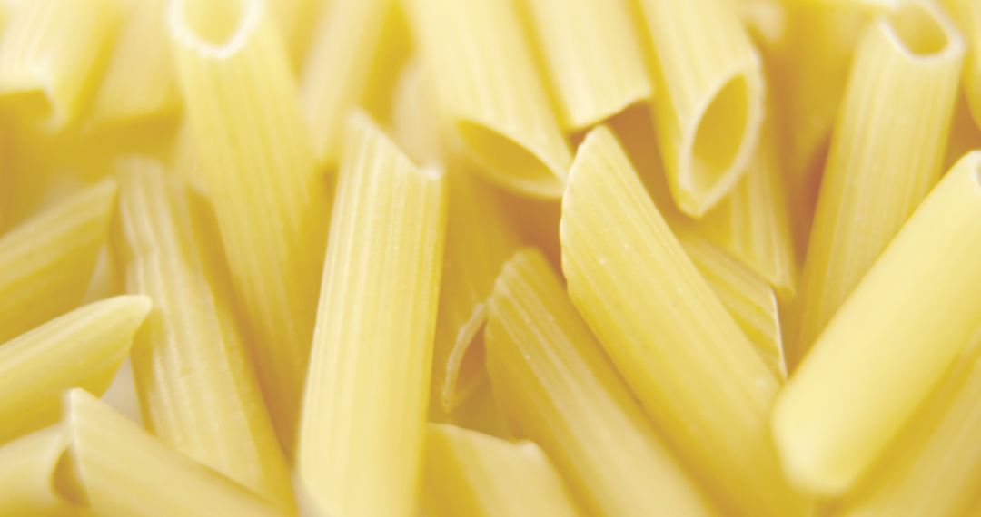 Close-up view of uncooked penne pasta with a soft focus background, with copy space - Free Images, Stock Photos and Pictures on Pikwizard.com