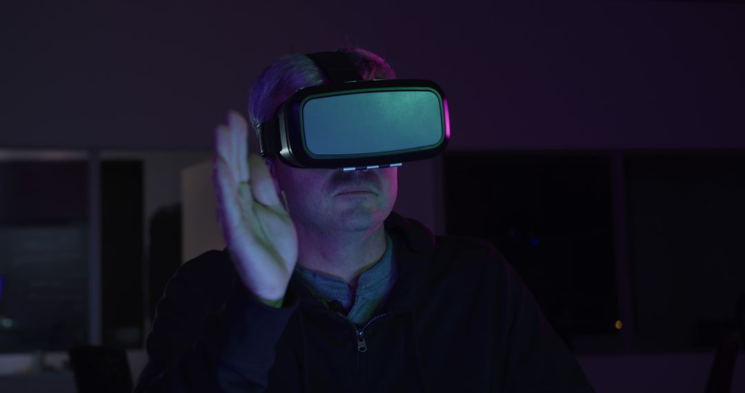 Man Exploring Virtual Reality at Night with VR Headset - Free Images, Stock Photos and Pictures on Pikwizard.com