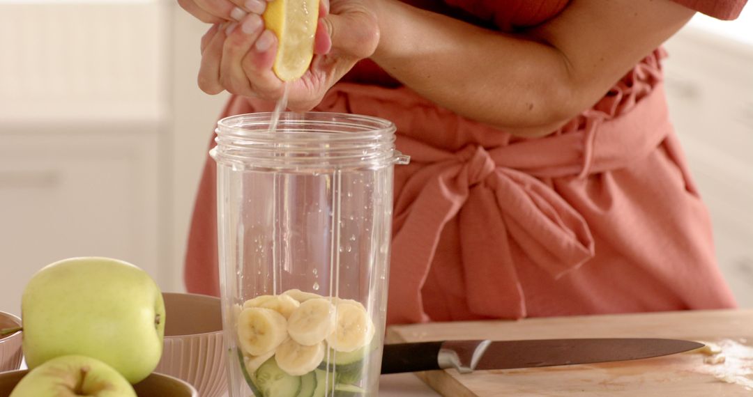 Preparing Fresh Smoothie with Sliced Produce in Sunlit Kitchen