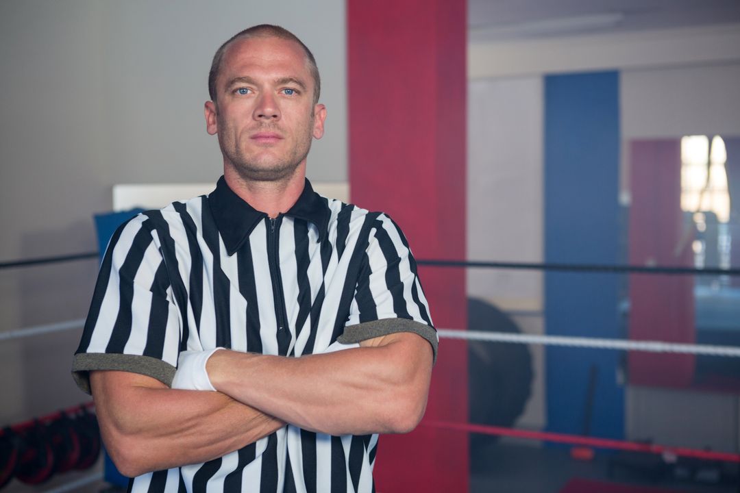 Portrait of male referee standing in with arms crossed - Free Images, Stock Photos and Pictures on Pikwizard.com