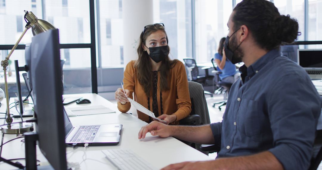 Colleagues in Office Discussing Work Wearing Masks - Free Images, Stock Photos and Pictures on Pikwizard.com