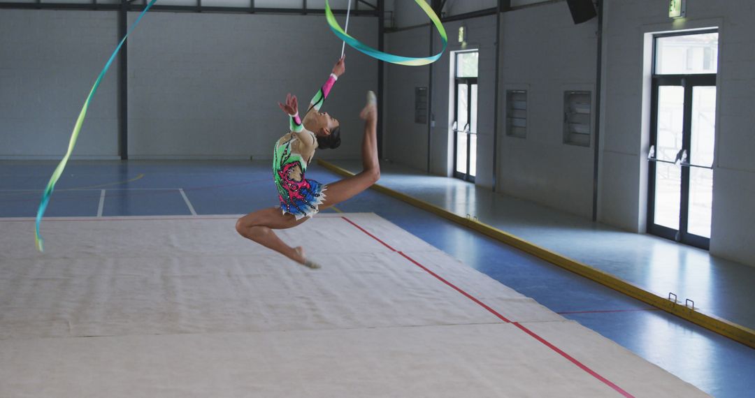 Rhythmic Gymnast Performing Ribbon Routine in Gymnasium - Free Images, Stock Photos and Pictures on Pikwizard.com