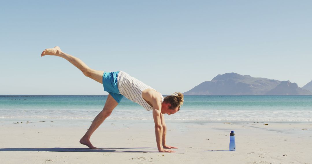 Man Practicing Yoga on the Beach in Morning Sunlight - Free Images, Stock Photos and Pictures on Pikwizard.com