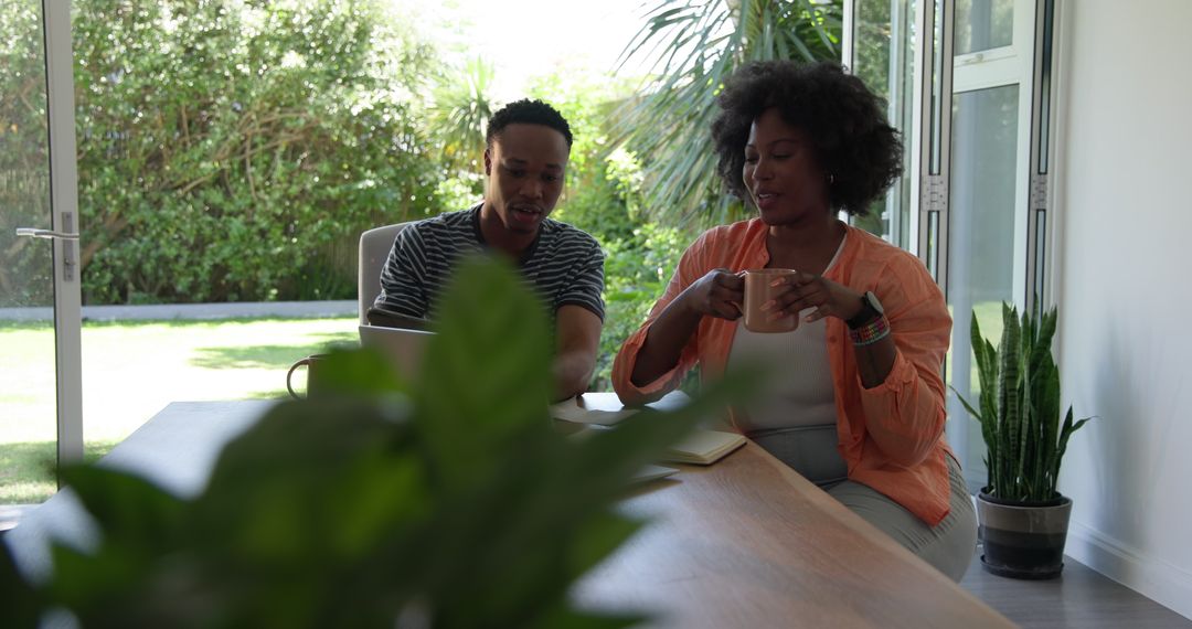 Couple Relaxing with Coffee While Working from Home