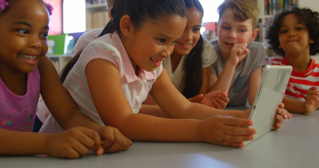 Diverse Schoolkids Collaborating on Tablet Learning Activity