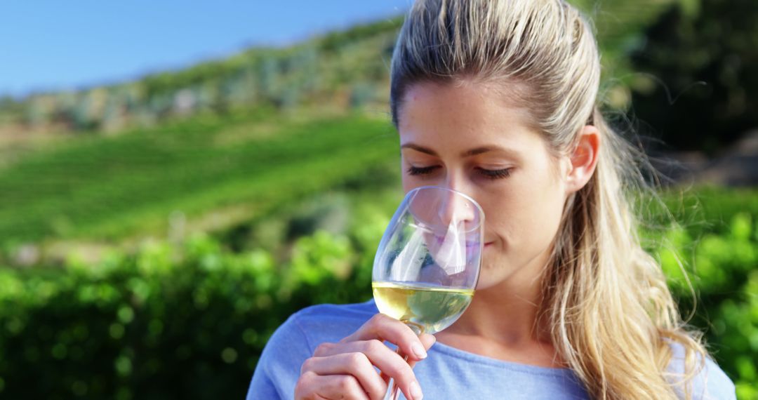 Woman Tasting White Wine in Vineyard on a Sunny Day - Free Images, Stock Photos and Pictures on Pikwizard.com