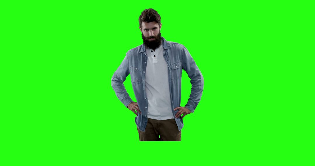 Bearded Man in Denim Shirt Standing Against Green Chromakey Background - Free Images, Stock Photos and Pictures on Pikwizard.com