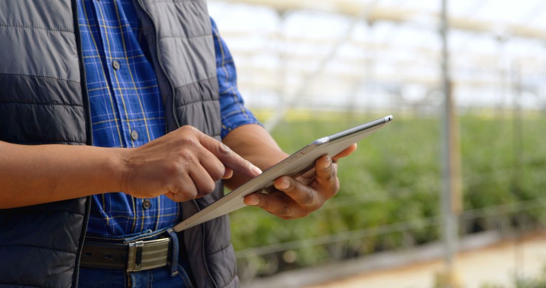 Farmer Using Digital Tablet in Greenhouse, Modern Agriculture Technology - Free Images, Stock Photos and Pictures on Pikwizard.com