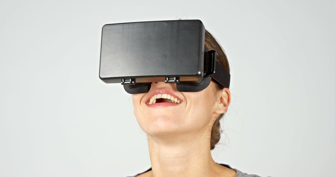 Woman Smiling While Using Virtual Reality Headset - Free Images, Stock Photos and Pictures on Pikwizard.com