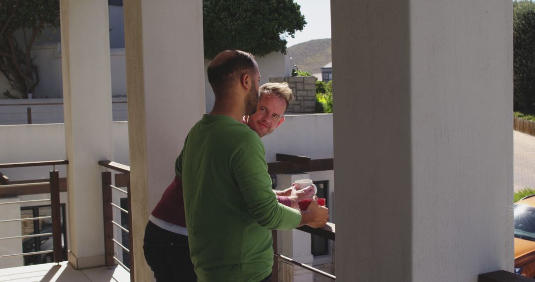 Two Friends Chatting on a Sunny Balcony - Free Images, Stock Photos and Pictures on Pikwizard.com