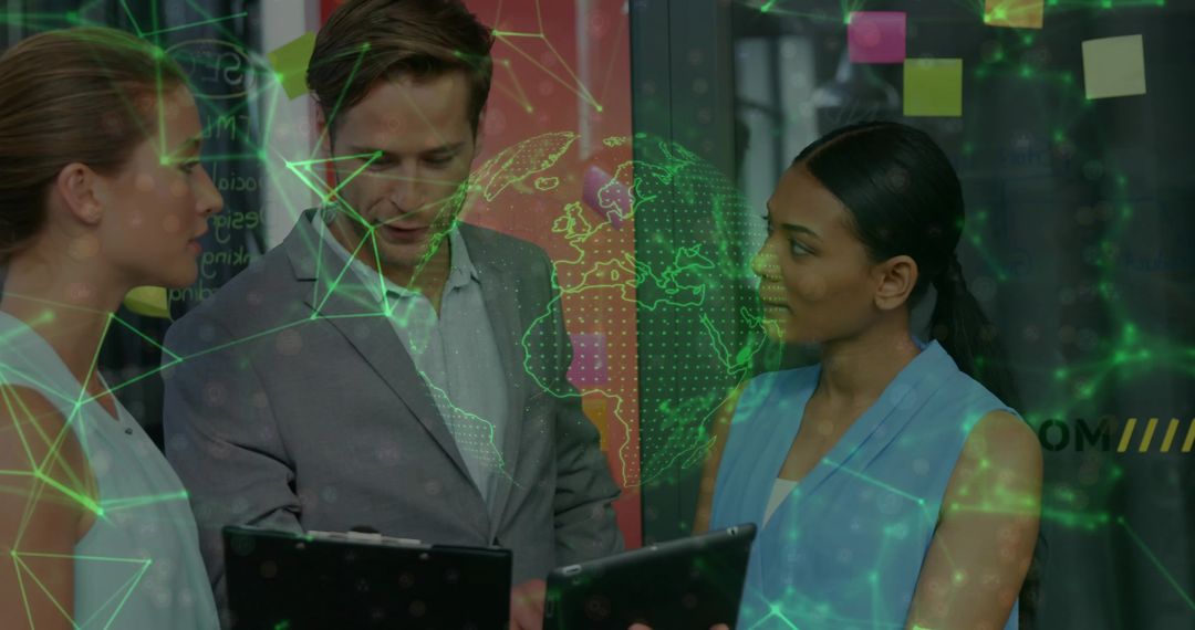 Three colleagues reviewing digital network visualization on tablets and clipboard