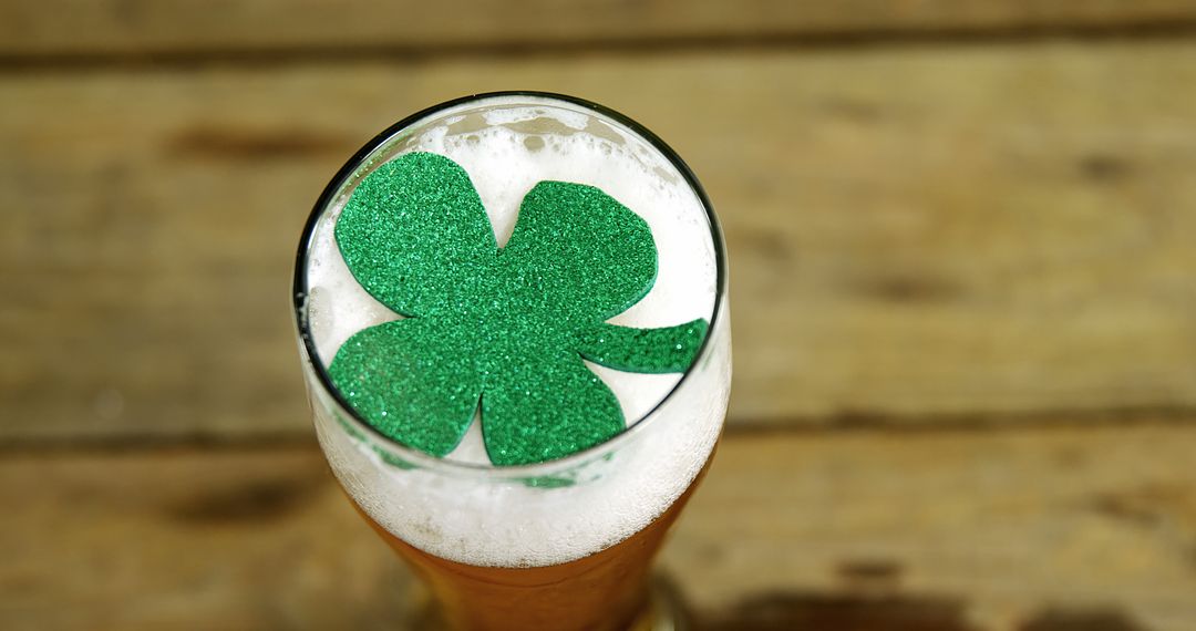 Close-up of Beer Glass with Green Shamrock Decoration on Wooden Table - Free Images, Stock Photos and Pictures on Pikwizard.com