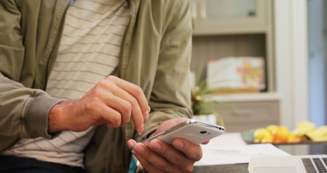 Man Using Smartphone While Sitting at Home - Free Images, Stock Photos and Pictures on Pikwizard.com