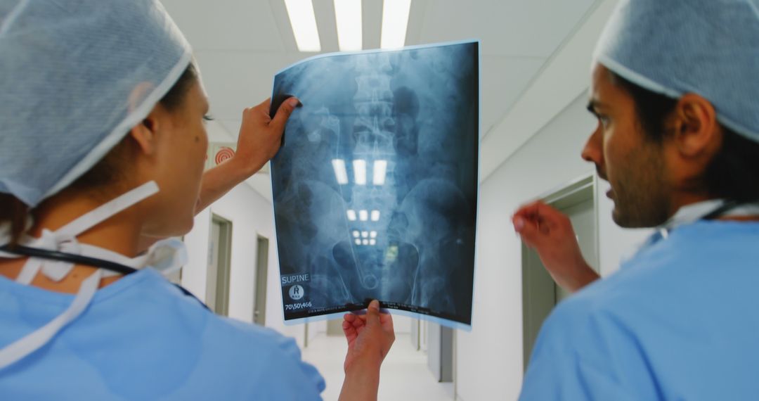 Doctors Analyzing X-ray Image in Hospital Corridor - Free Images, Stock Photos and Pictures on Pikwizard.com