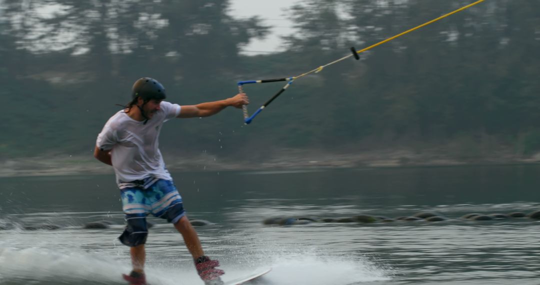 Man Wakeboarding on Lake with Forest Background - Free Images, Stock Photos and Pictures on Pikwizard.com