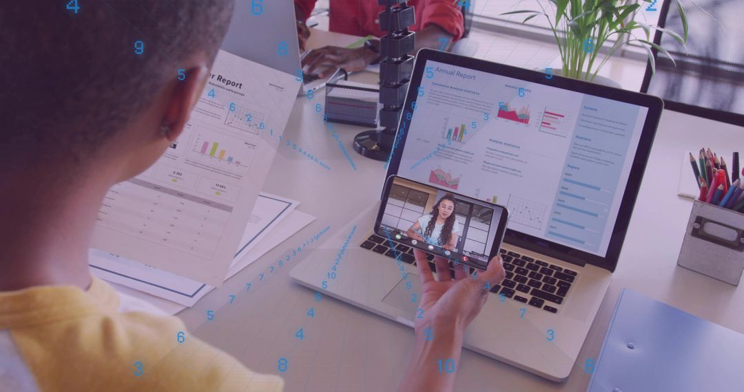 Professional Analyzing Reports With Smartphone and Laptop for Data Insights