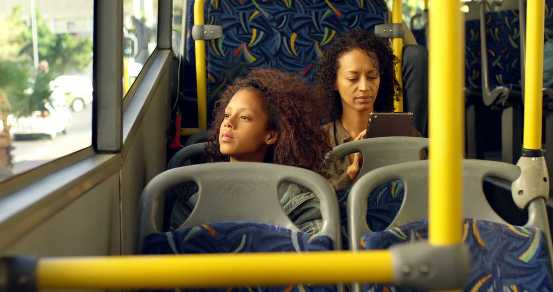 Two Women on Public Bus Making Use of Commute Time - Free Images, Stock Photos and Pictures on Pikwizard.com